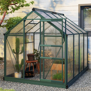 Greenhouse with plants and furniture outside, set against a wooden wall.