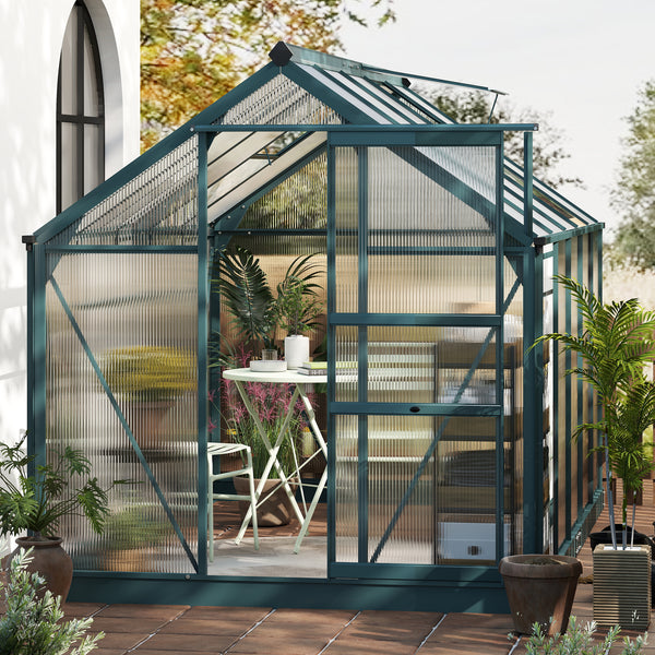 Greenhouse with a view into a garden area with plants and furniture
